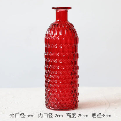Red and orange glass terrarium vases grouped as eclectic shelf styling