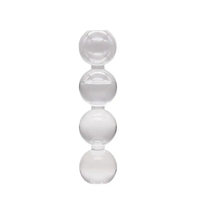 Three colored glass hydroponic vases in transparent pink and blue grouped on white shelf