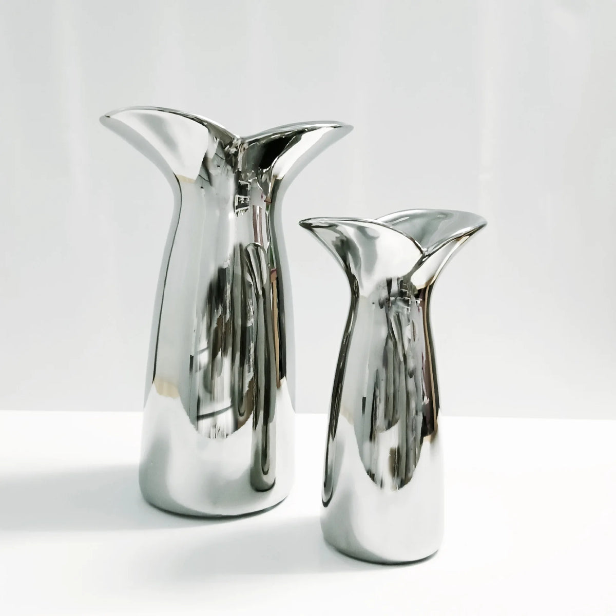 Small wabi-sabi electroplated Nordic vase with irregular organic form on console table