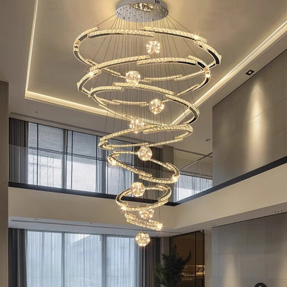 Four ring crystal chandelier lit in warm white above a table