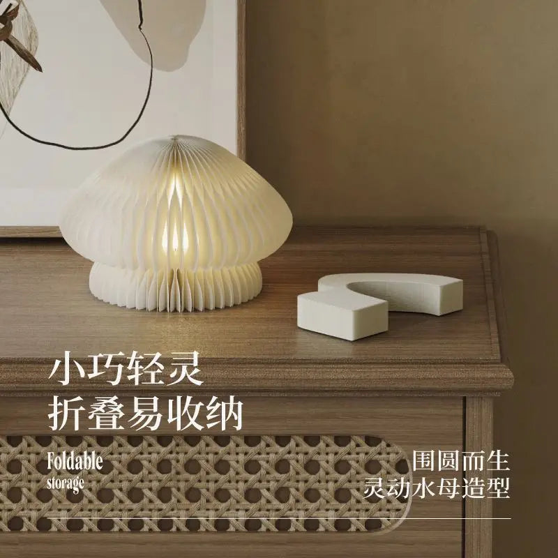 Paper jellyfish lamp glowing warm white on bedroom nightstand