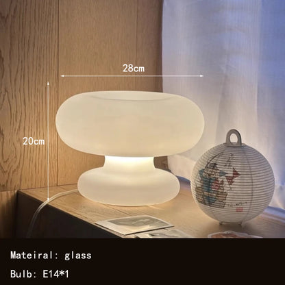 Art Deco glass table lamp in a modern living room setting with warm ambient light