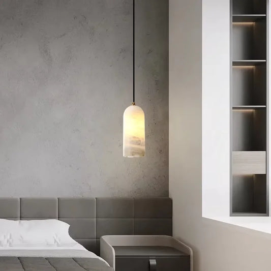 Golden natural marble chandelier with a solid stone shade lit from within