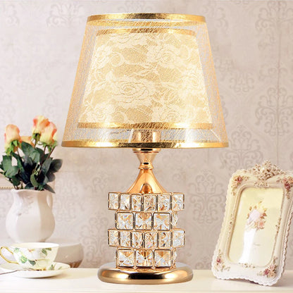Gold crystal lamp diamond facets close-up reflecting warm light