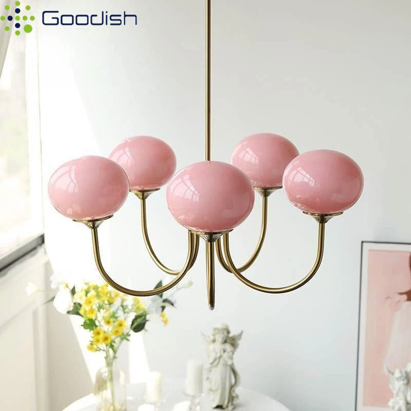 Cream frosted glass globes set on the chandelier polished chrome arms