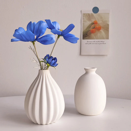 White Nordic ceramic flower vase on wooden shelf display