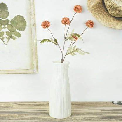 Close-up of smooth matte white plastic finish on Nordic-style round indoor flower pot