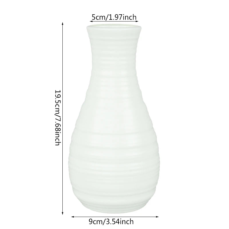 Three Nordic white plastic flower pots in natural light with assorted small houseplants