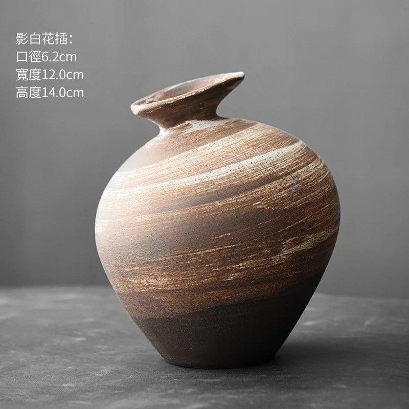 Pair of abstract terracotta stone-finish vases in contrasting shapes