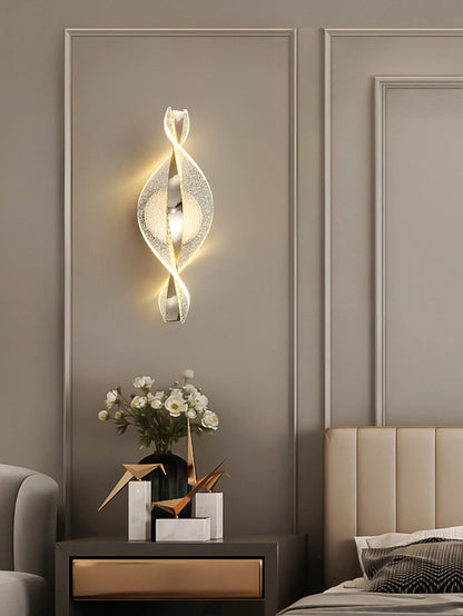 gold and black acrylic outdoor wall sconce, detail view of fixture base and arm