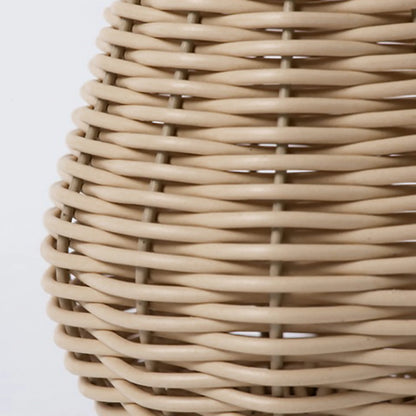 Close-up of textured plastic rattan weave surface detail on handwoven flower vase