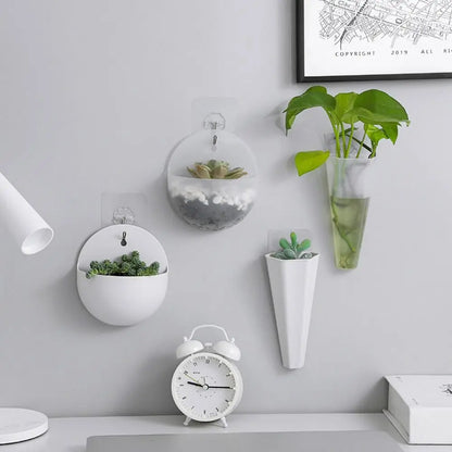 White conical acrylic wall hanging planter mounted on clean white interior wall