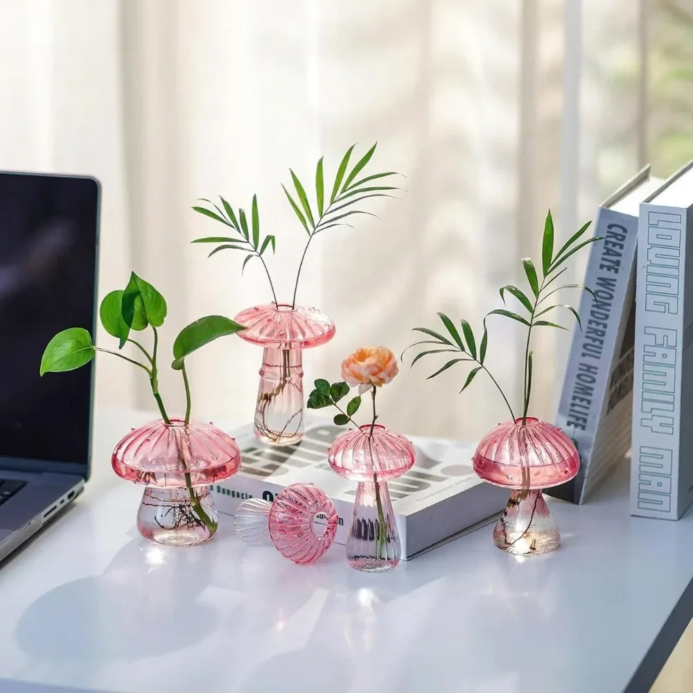 Clear mushroom-shaped ribbed glass vase holding green plant cutting in water