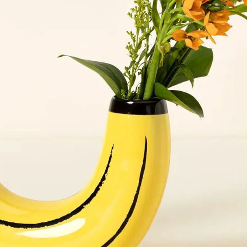 Resin banana-shaped novelty vase as living room accent on bookshelf