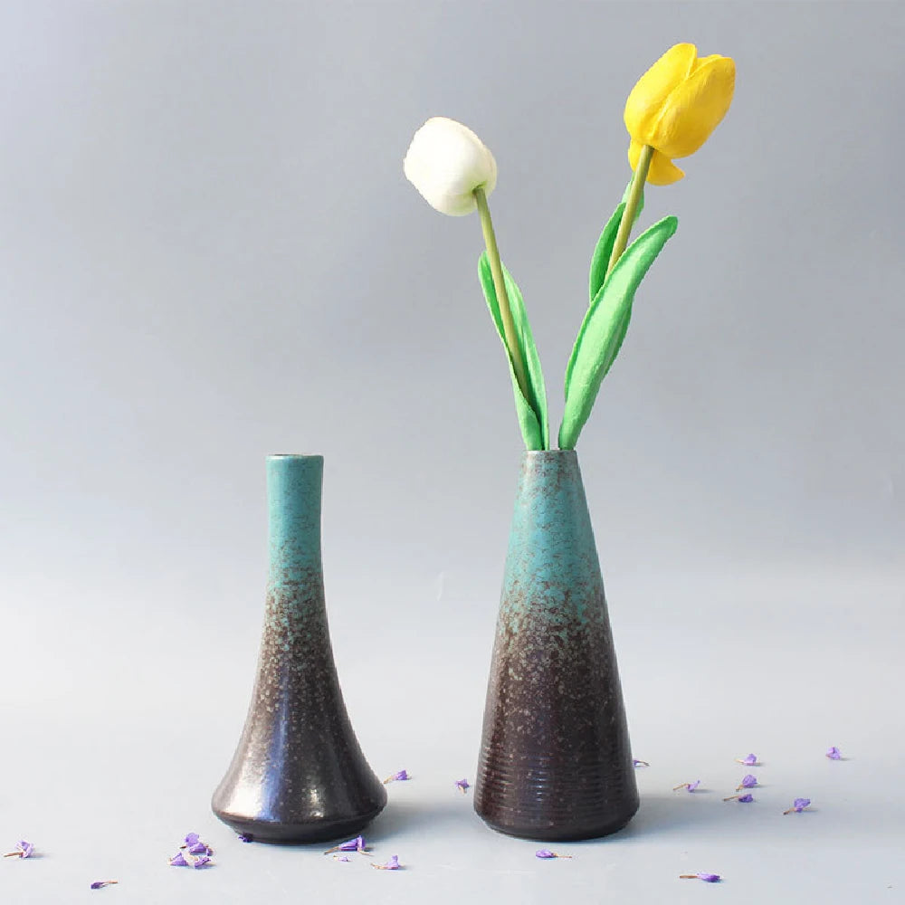 Matte black ceramic bud vase shape E with dried botanicals on Japandi shelf