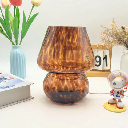 Colorful glass mushroom lamp illuminated in dim bedroom environment