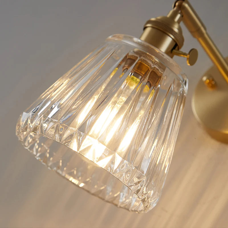 brass bathroom wall sconce, detail view of fixture base and arm