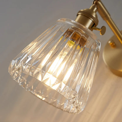 brass bathroom wall sconce, detail view of fixture base and arm