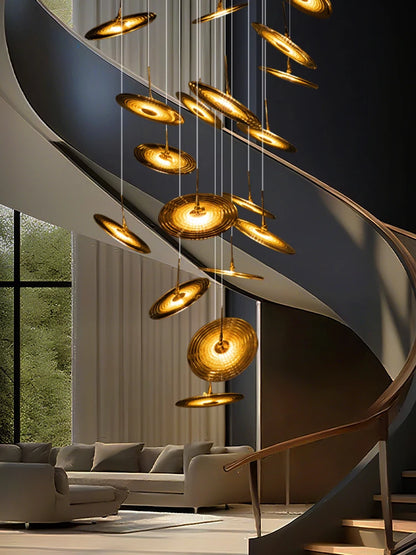 Thirty six light spiral chandelier dropping through a stair void
