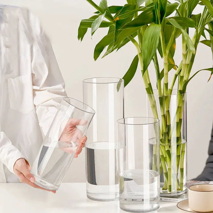Small 20cm clear acrylic vase with fresh mixed flowers on desk