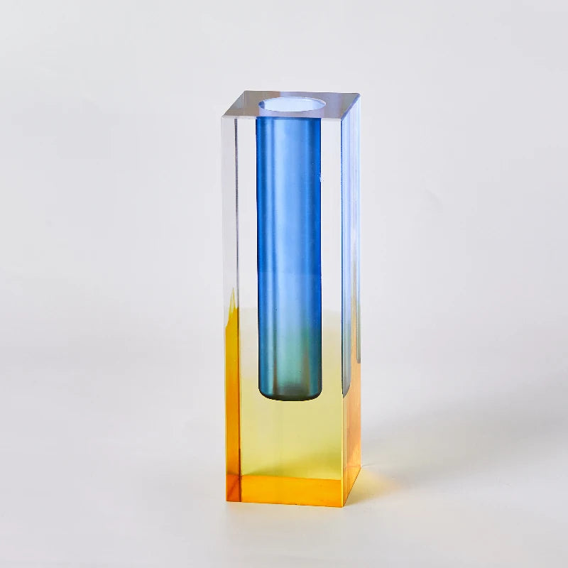Multiple frosted acrylic pillar bud vases in gradient pastel tones displayed together