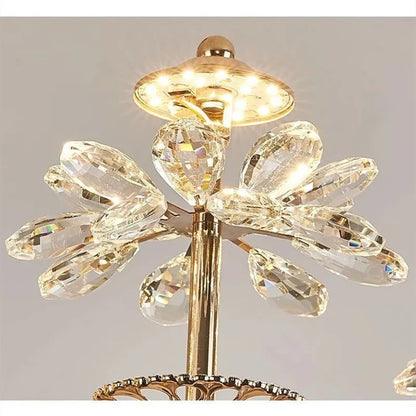 Gold flower chandelier with crystal set across each carved petal