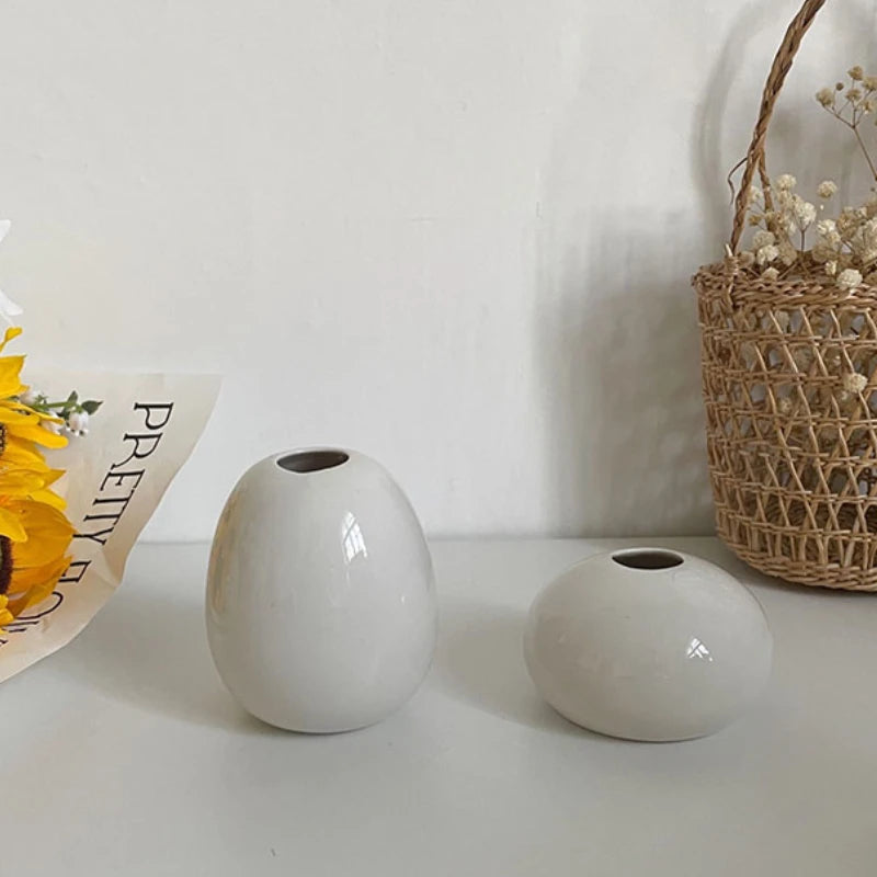 Ceramic mini vase set styled with small blooms on desk