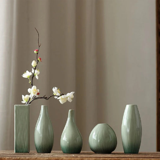 Pink F style ceramic bud vase with smooth finish on home shelf