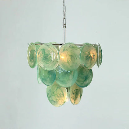 Turquoise stained glass disc detail on a polished steel chandelier arm