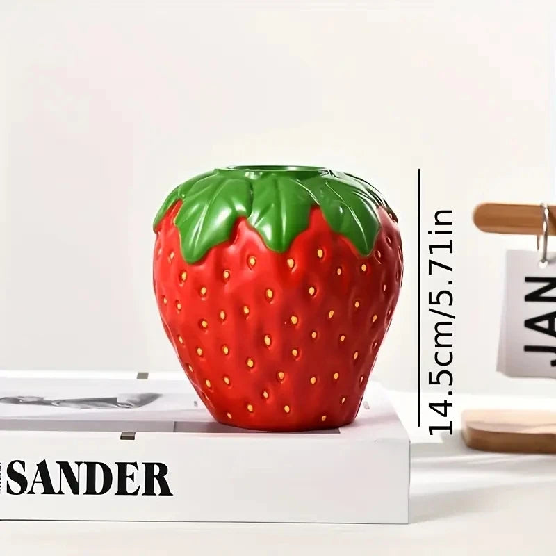 Side view of red ceramic strawberry vase showing sculptural form detail