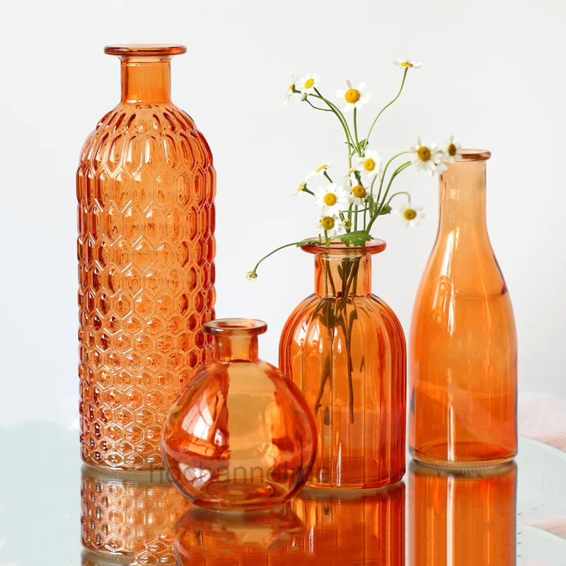 Orange glass terrarium-style flower vase styled in maximalist living room