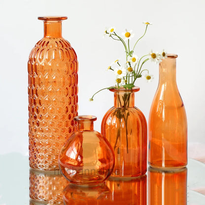 Orange glass terrarium-style flower vase styled in maximalist living room
