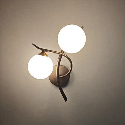 glass wall sconce, detail view of fixture base and arm