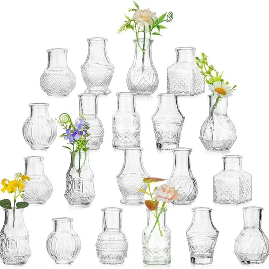 Set of 20 clear relief glass mini vases arranged on wedding table