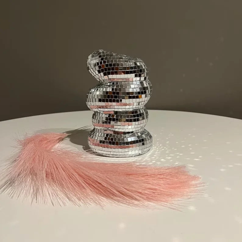 Three disco ball vases in silver, hot pink, and gold together