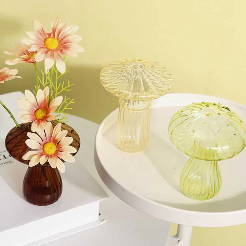 Bright glass mushroom-shaped vase in style B with fresh flower on shelf