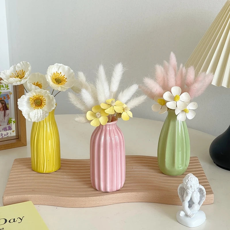 Small ceramic flower pot ornament on desk with blooms