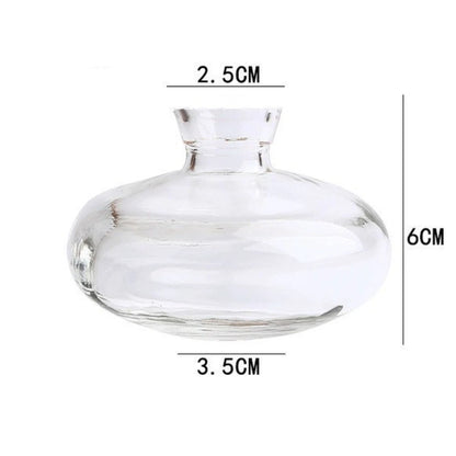 Mini glass vase with single flower stem on dining table display