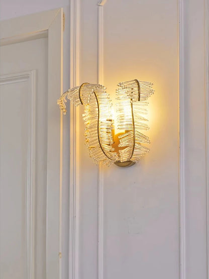 Feather crystal chandelier lit in warm light over a dining table
