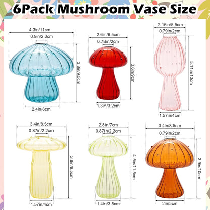 Transparent mushroom glass vase with dried wildflower stem on white shelf