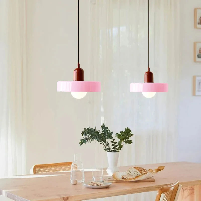 Orange tinted glass chandelier casting a warm focused pool of light