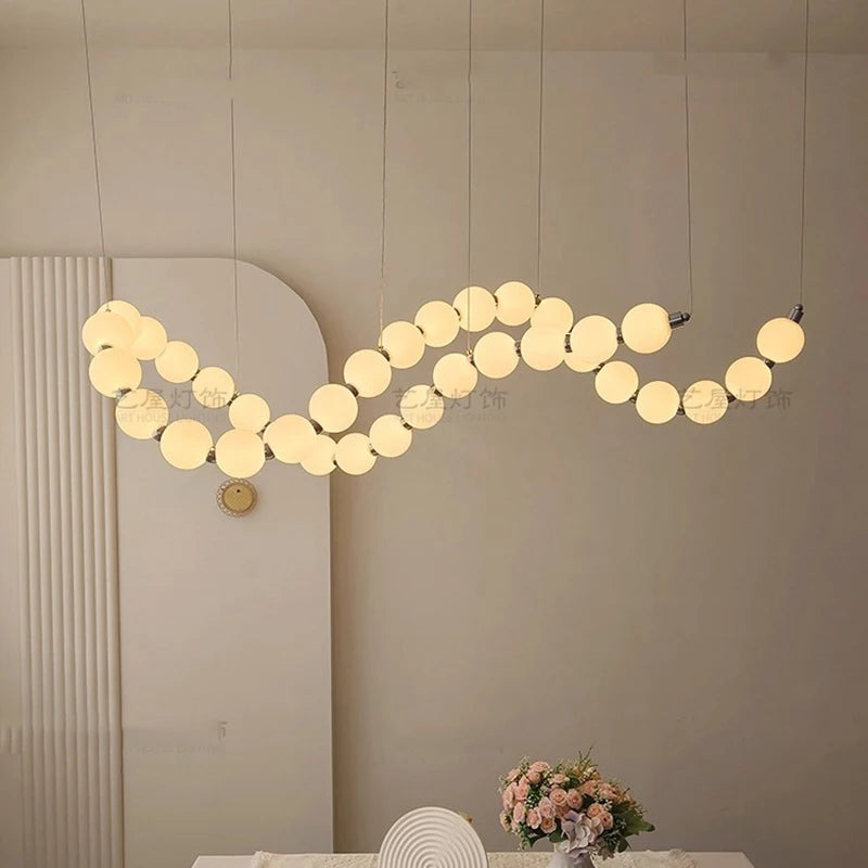 Silver strip chandelier at 57.5 in length with remote dimming