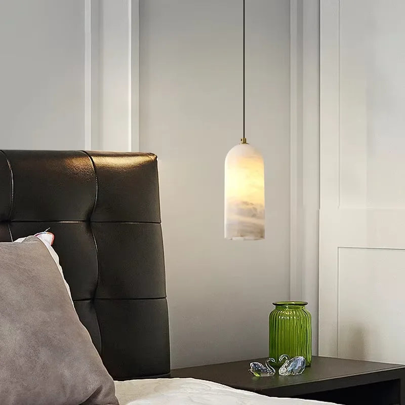 Natural marble chandelier showing veining picked out by warm light