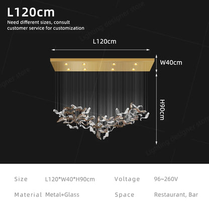 Linear glass chandelier shown lit in warm 3000K LED light