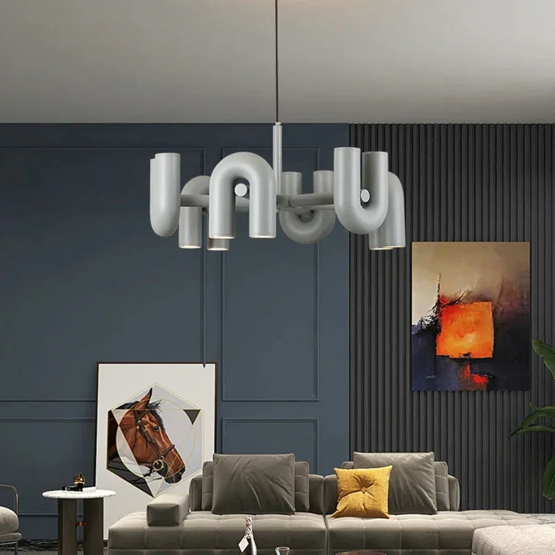 Grey U shaped chandelier washing light upward from a shadeless body