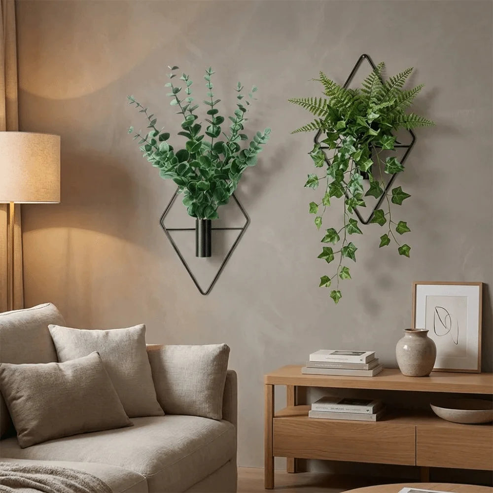 Black iron diamond-shaped wall vase with small wildflower spray in modern entryway