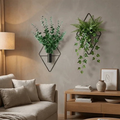 Black iron diamond-shaped wall vase with small wildflower spray in modern entryway