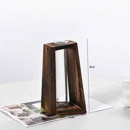 Wooden retro hydroponic vase with herb cuttings on home office desk display