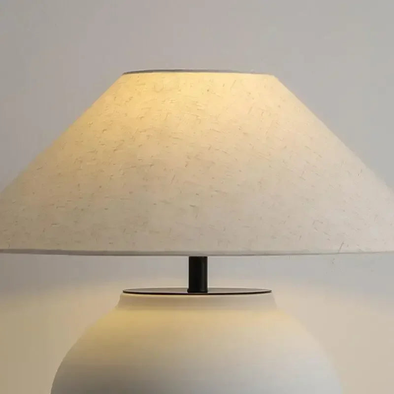 Nordic ceramic table lamp in living room setting warm amber glow