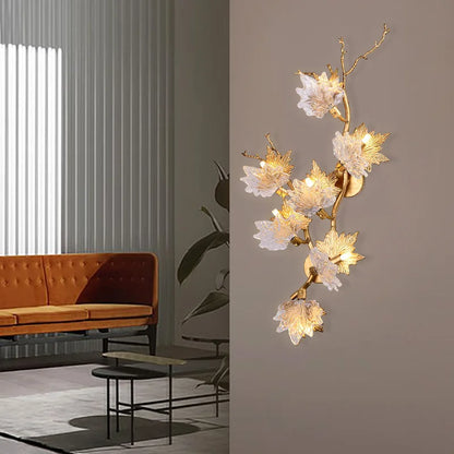 Crystal leaf detail on a plated gold chandelier frame with dimmable LED light